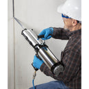 Worker filling wall crack with the Nordson EFD 2K Manual Top Load Dispenser