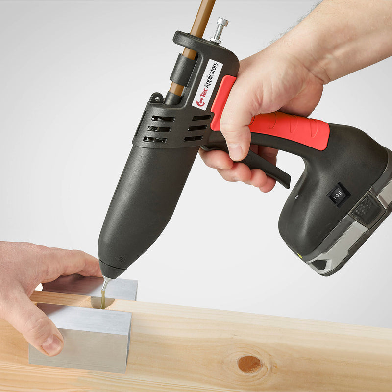 Handheld application of the Power Adhesives Knottec 808-12 glue gun, dispensing adhesive into a wooden joint.