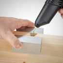 Close-up of the Knottec 808-12 glue gun applying adhesive to a wood joint using swatch heat sync blocks