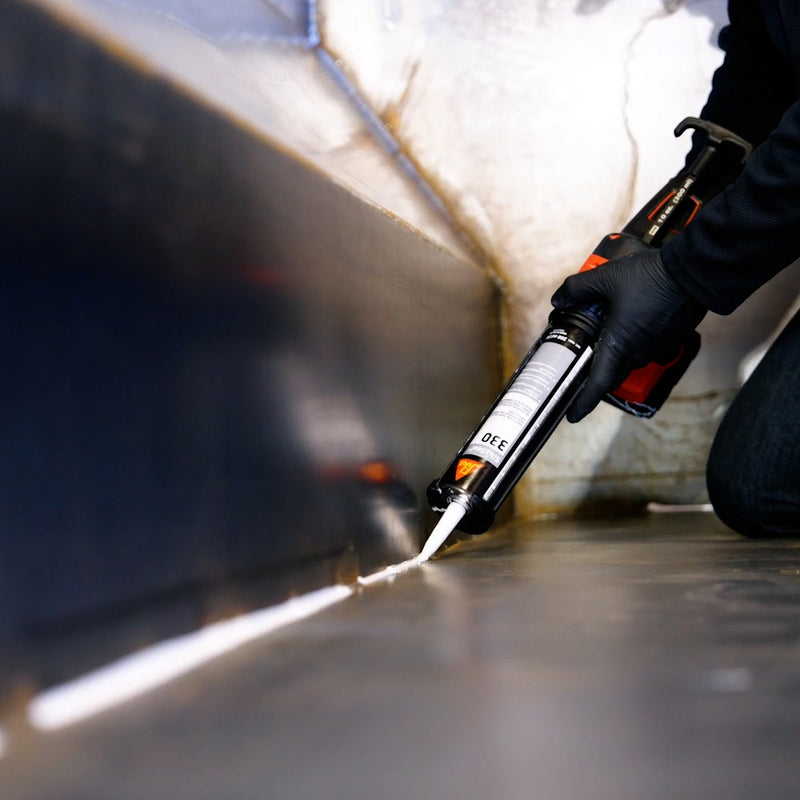 Worker Applying SikaSeal 330 Heat Curing Seam Sealant in a Dumpster